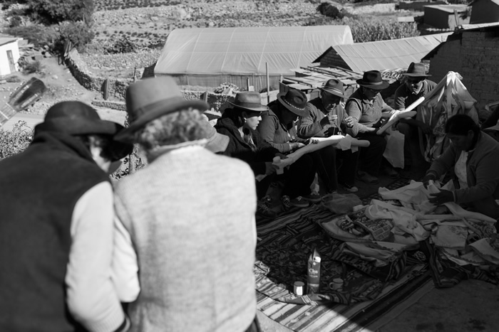 La comunidad devota de la Cruz, luego de un almuerzo tradicional, viste las cruces de Milagro con mantos bordados y cintas. Acompañados de cantos, guitarra y violín, hombres y mujeres trabajan en la ornamentación de las cruces.
